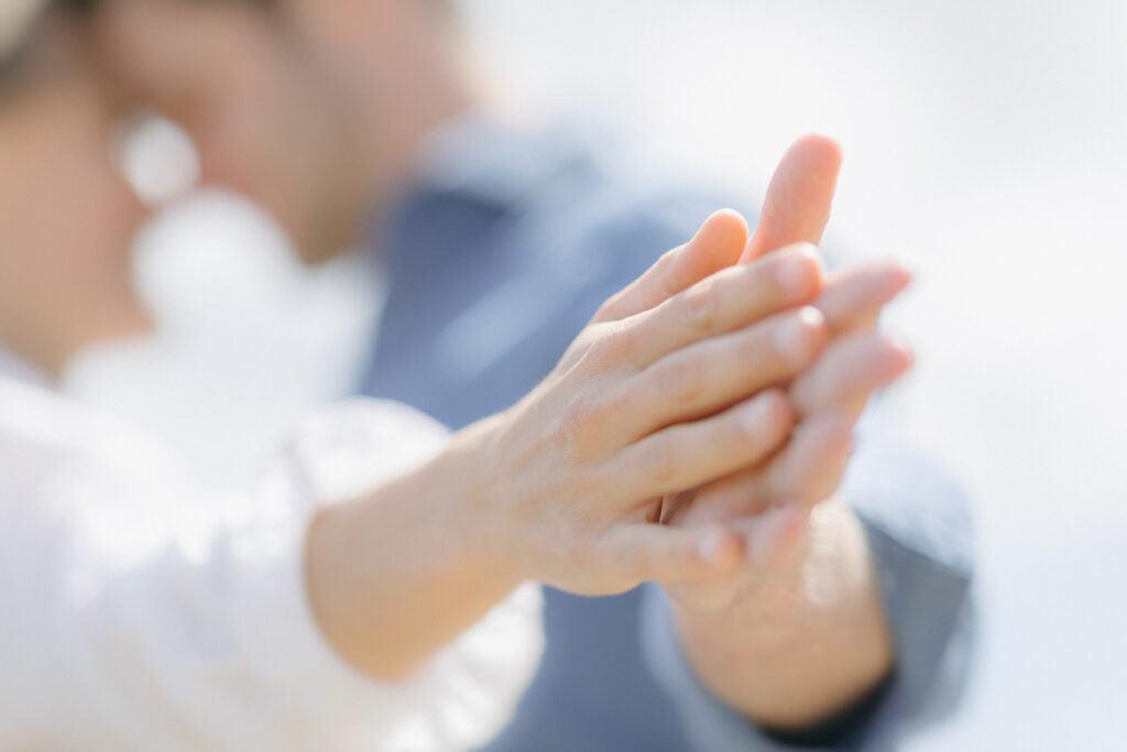 Engaged couple touching hands