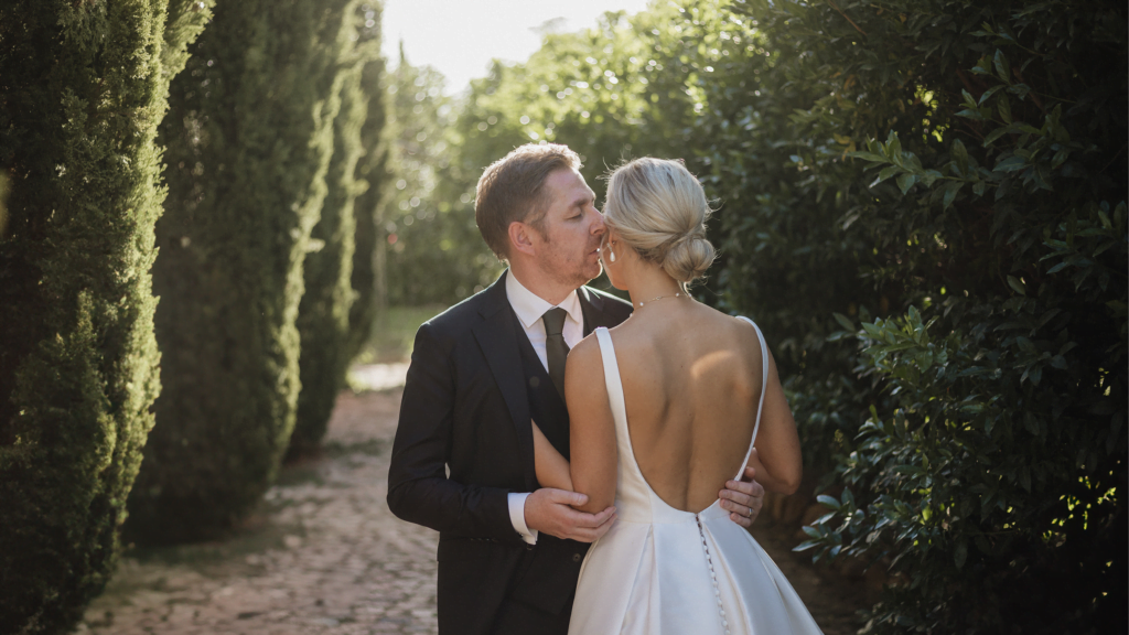 Wedding couple between tall trees