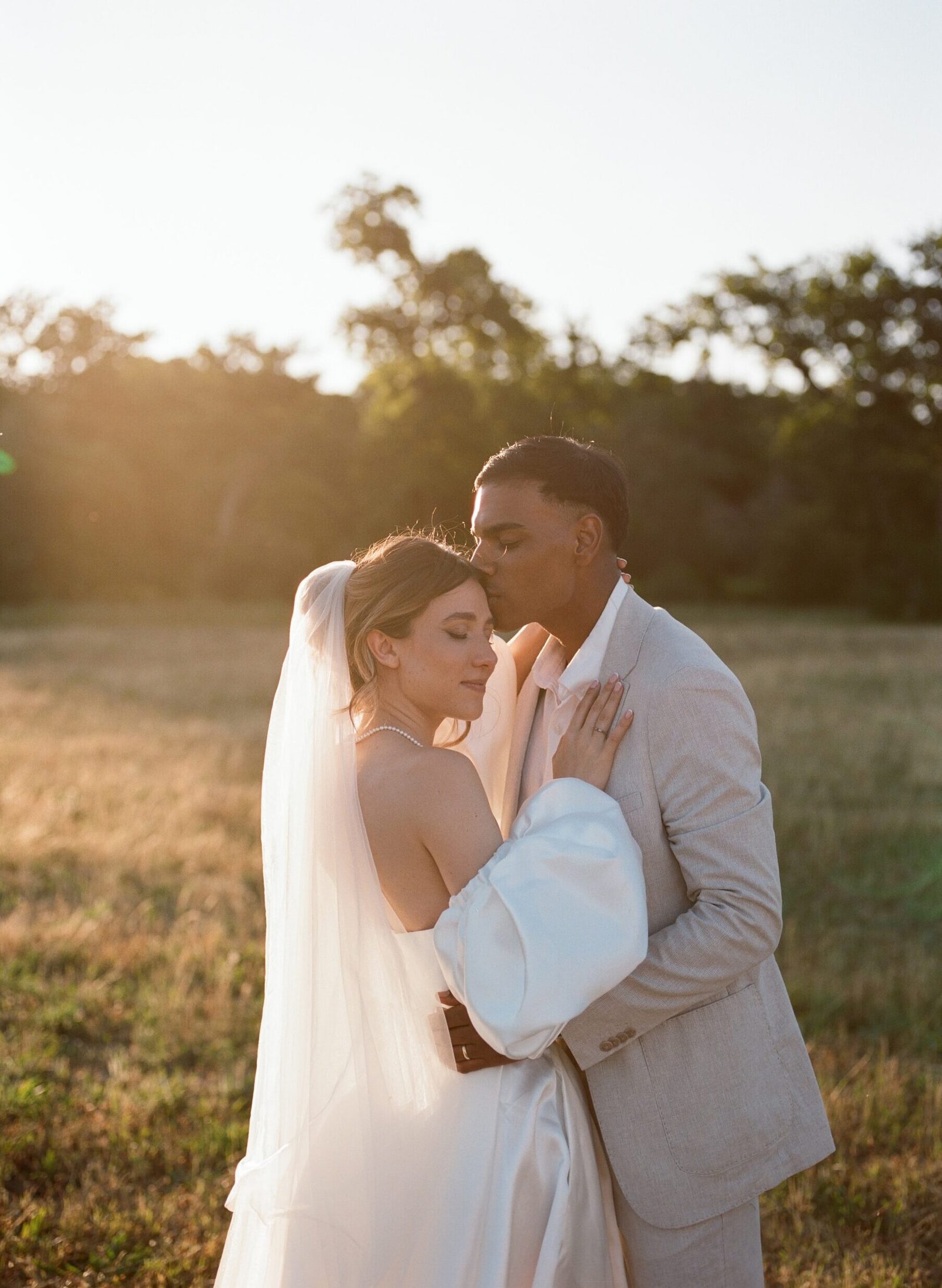 A wedding couple in a field shot on film
