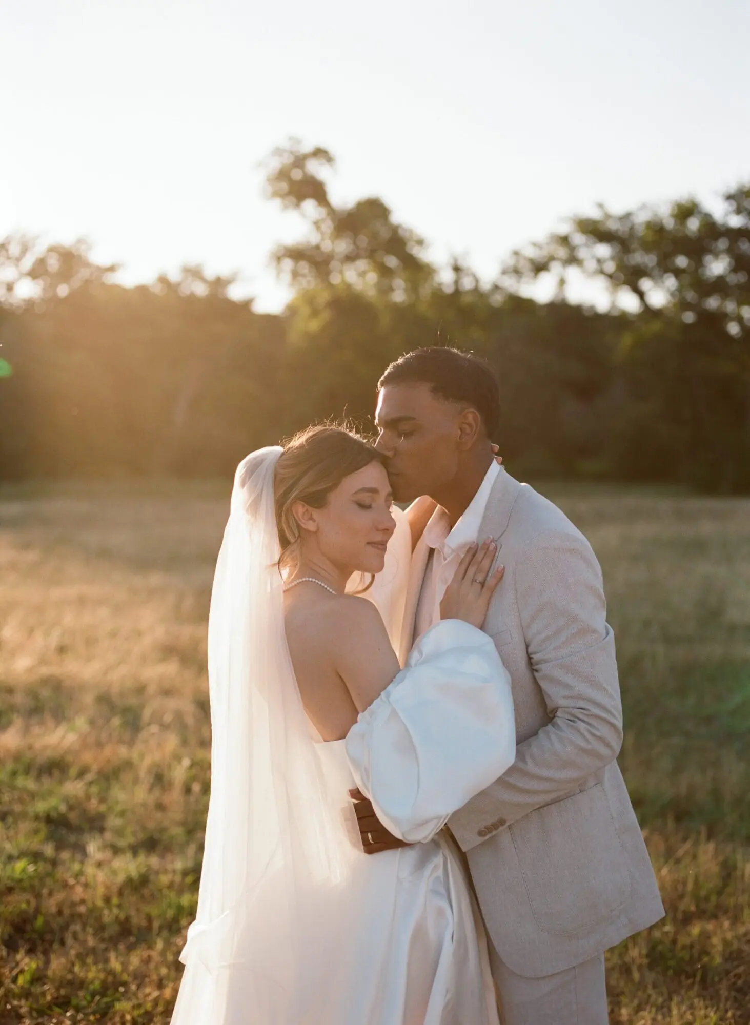 A wedding couple in a field shot on film