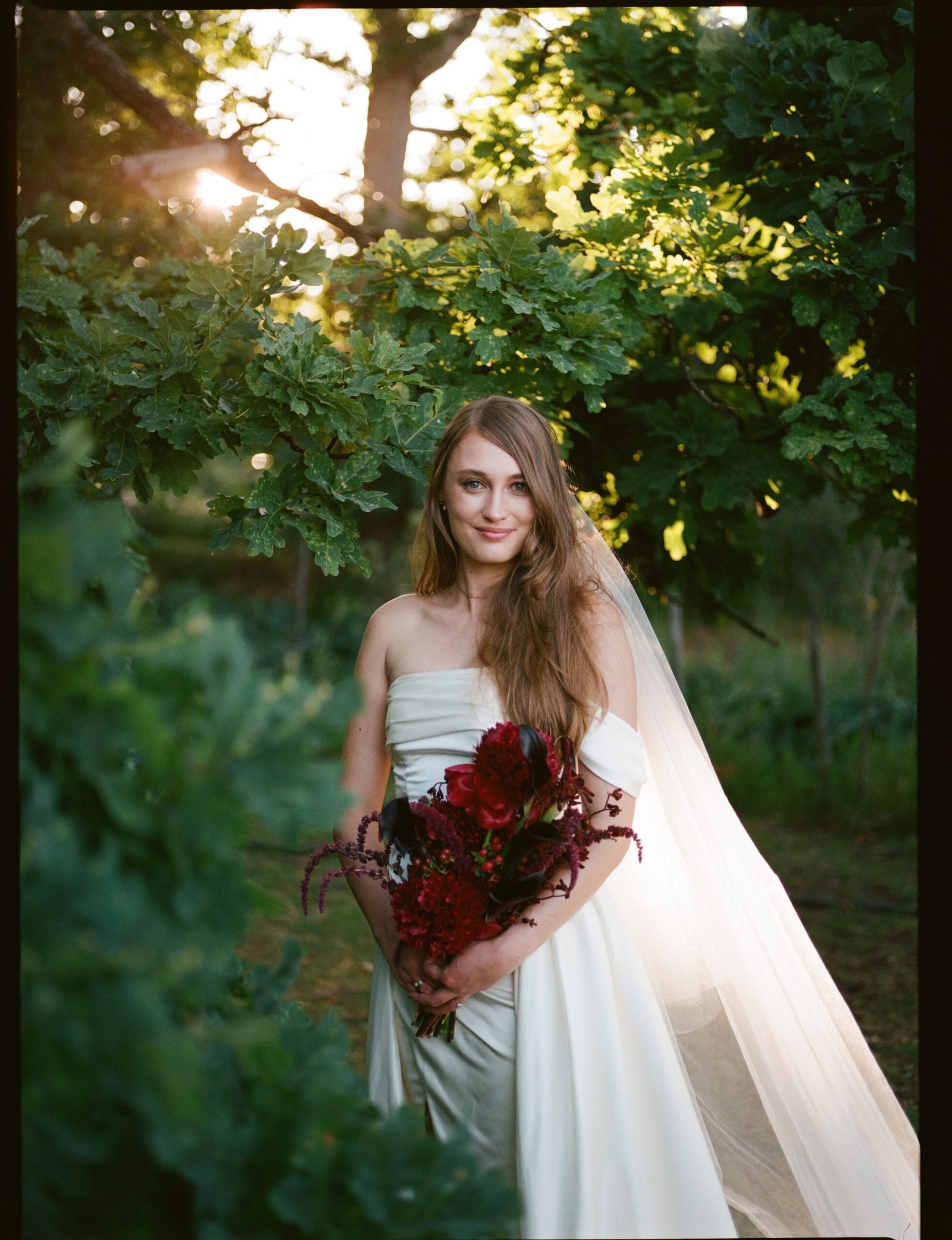 Wedding photo on 120 film of a bride among foliage.