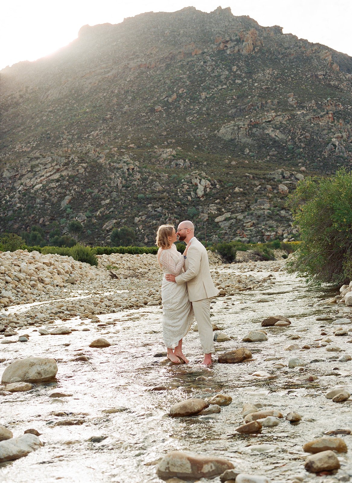 Wedding couple on film, whilst standing in a river
