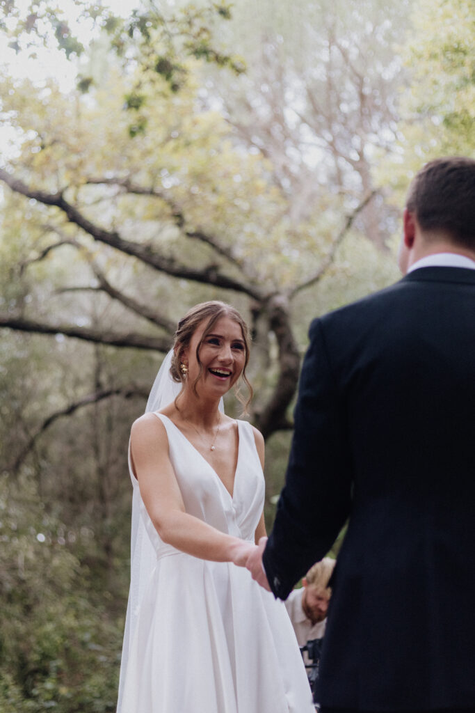 Bride laughing during wedding ceremony