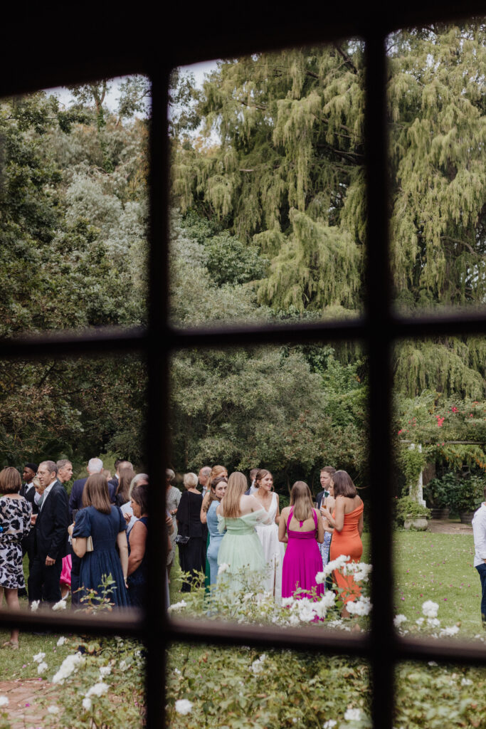 Candid image of a bridal party through a window