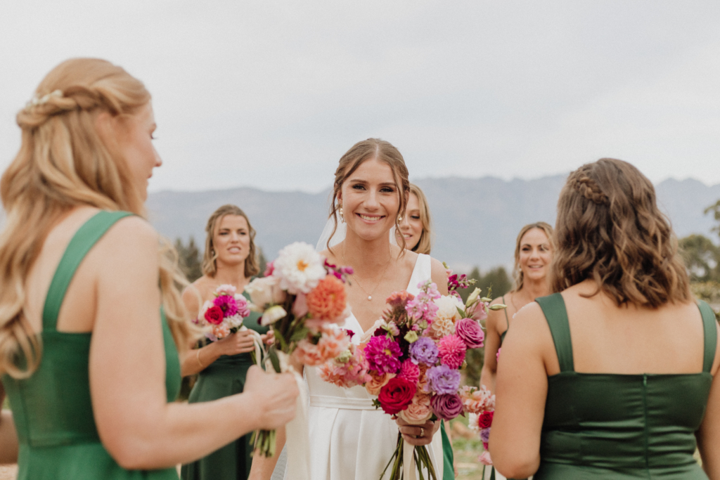 Candid bridal party with mountain backdrop