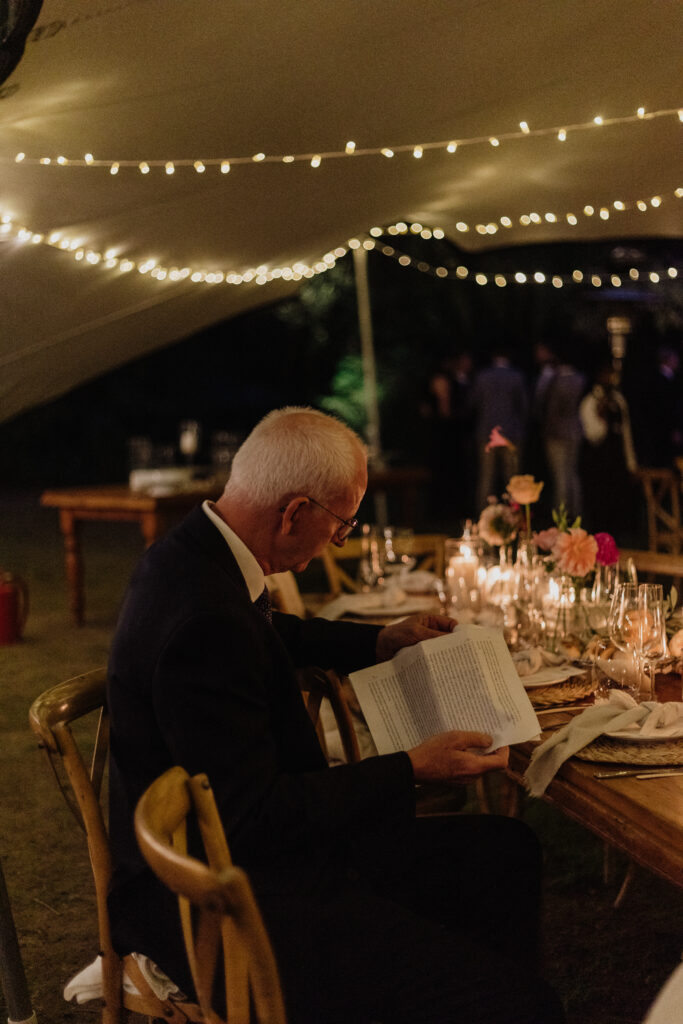 Dad going over wedding speech at reception