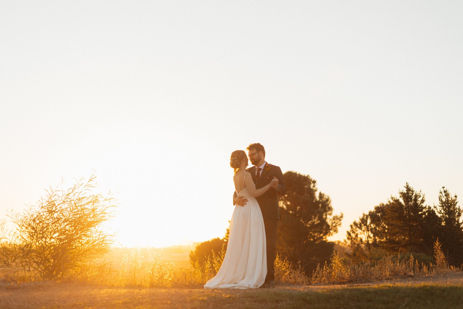 Couple dancing with African sunset behind them