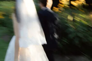 Motion blur image of a wedding couple walking past.