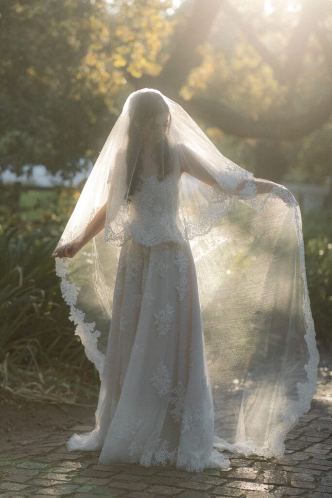 Bride, sunlit from the back at Natte Valleij wedding venue