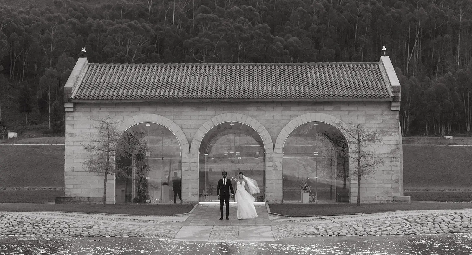 Black and white wedding photo of a wedding couple standing outside the sanctuary at La Roche