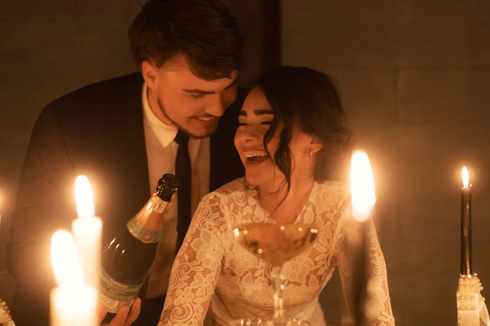 Close up a wedding couple laughing by candle light