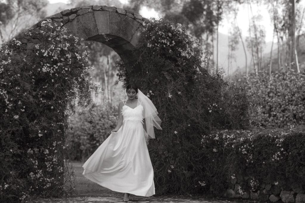 Bride standing at a stone entranceway