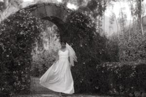 Bride standing at a stone entranceway