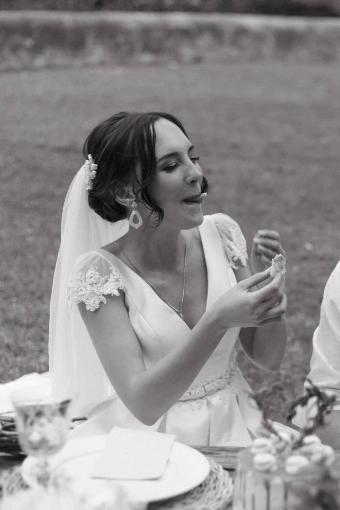 Bride licking wedding cake off of her lip