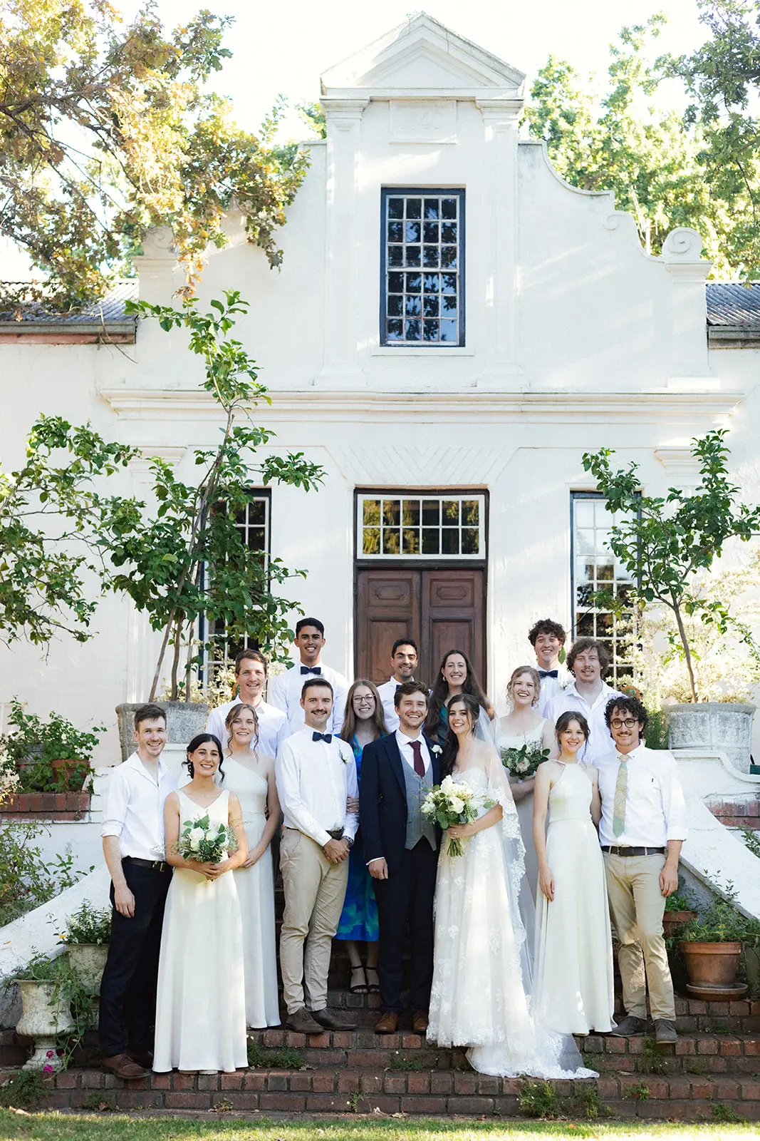 Wedding party standing in front of a historic manor house in Cape Town.