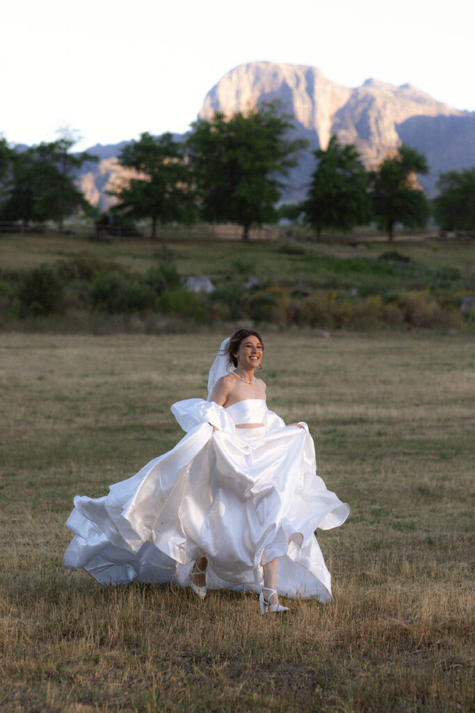 Bride running in a field during her wedding at La Plasir Estate
