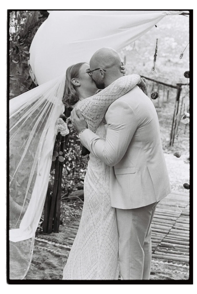 Black and White film image of a couple doing their first kiss